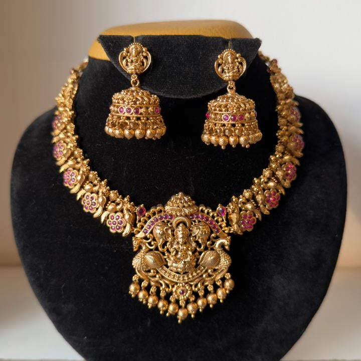 Nakshi-style necklace with a prominent central pendant depicting Goddess Lakshmi, symbolizing prosperity.