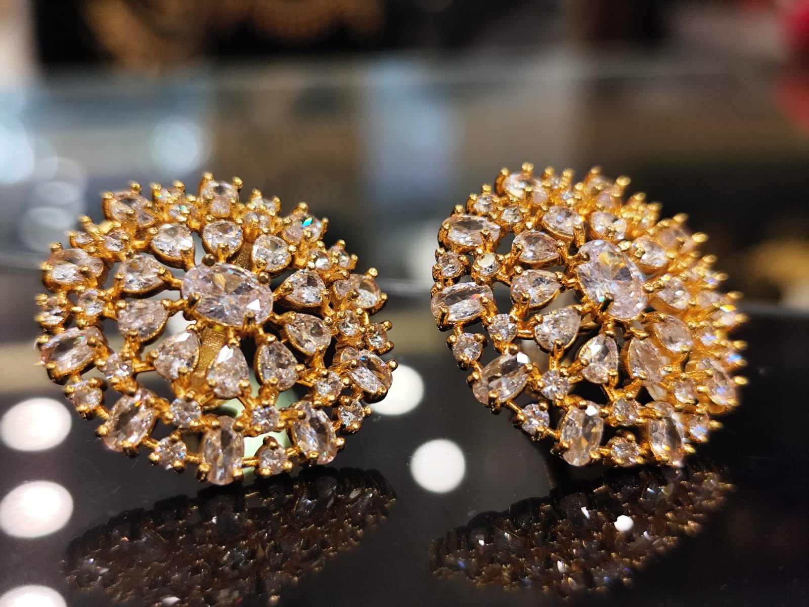 Elegant gold stud earrings with layered white stones