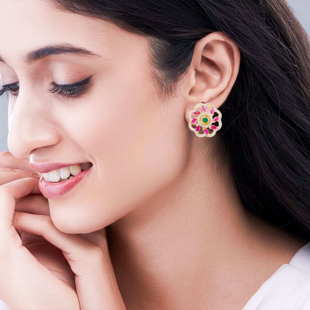 Floral stud earrings with pink and green stones.