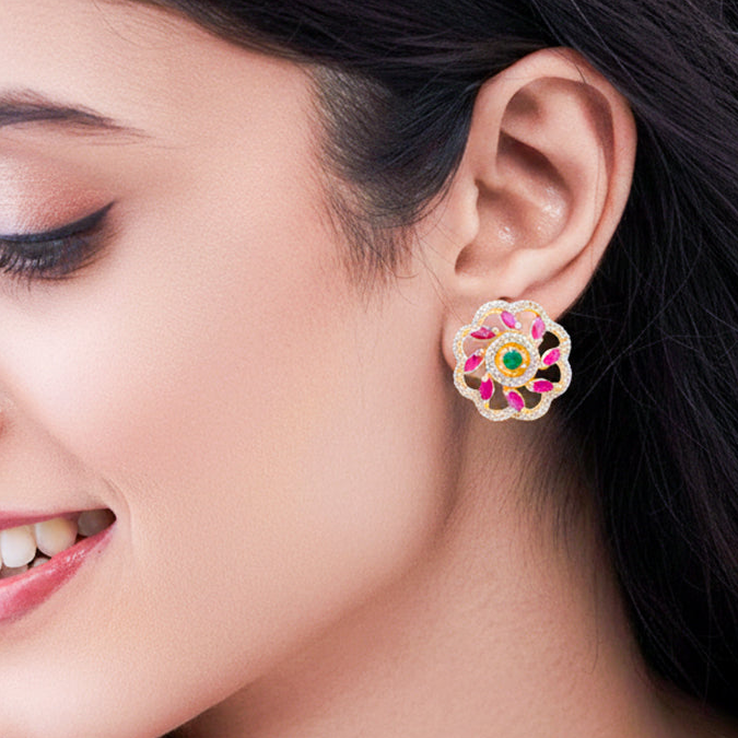 Floral stud earrings with pink and green stones.
