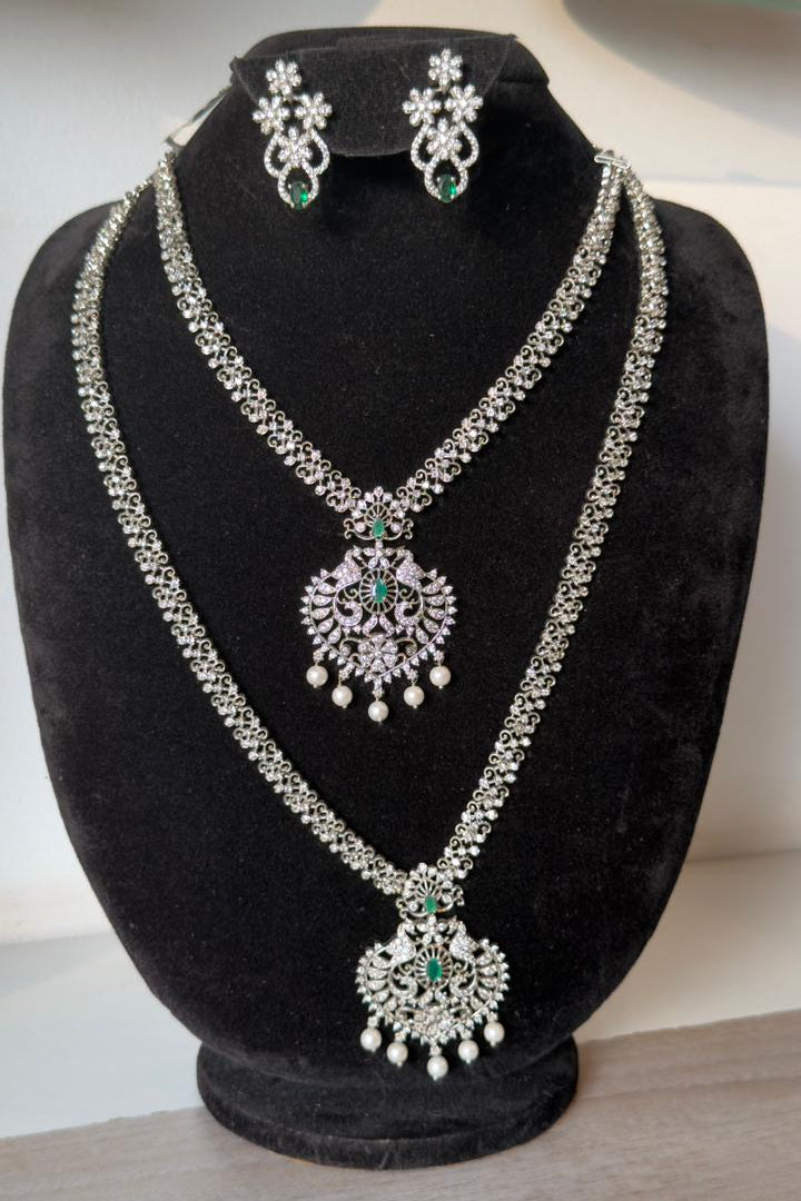 Elegant silver-tone layered necklace set with matching earrings.