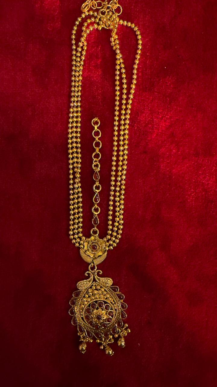 Traditional gold maangteeka with intricate filigree work