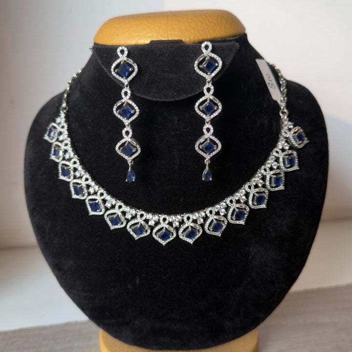 Elegant silver-tone necklace set with matching long earrings.