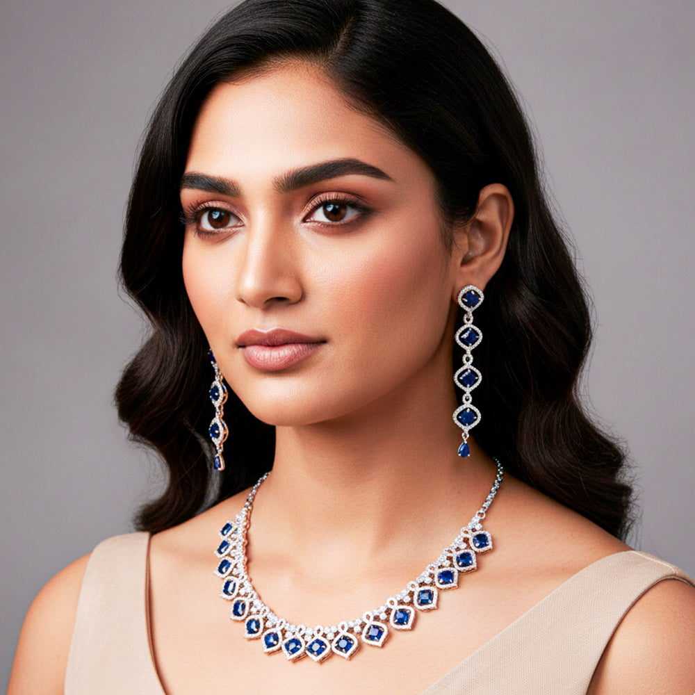 Elegant silver-tone necklace set with matching long earrings.