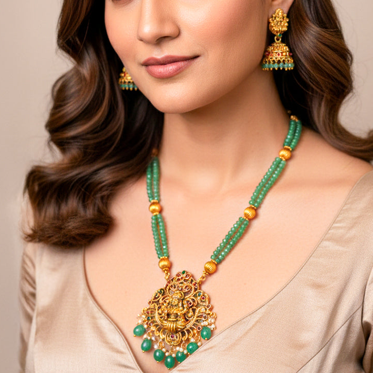 Elegant Temple Jewelry set features a double-strand necklace of mint green beads and an antique gold-finish pendant of Goddess Lakshmi.